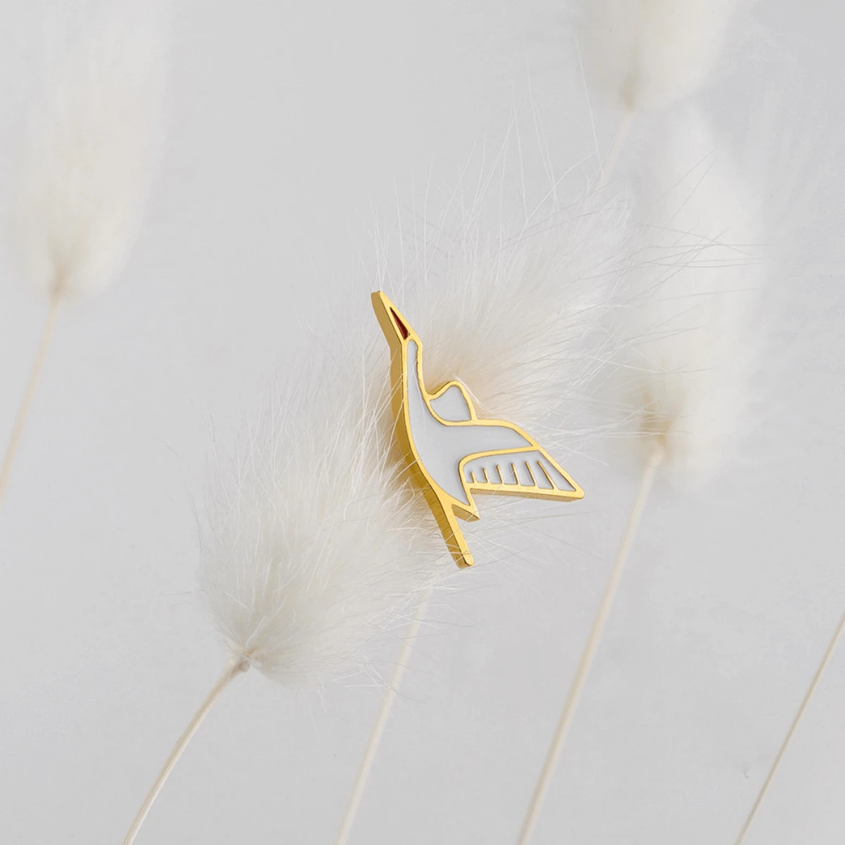 złoty pin bocian